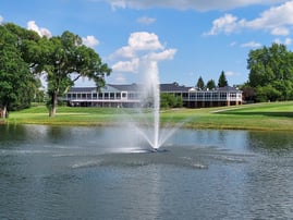 country club pond with fountain in front of clubhouse
