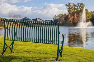 fountain in a pond with bench 